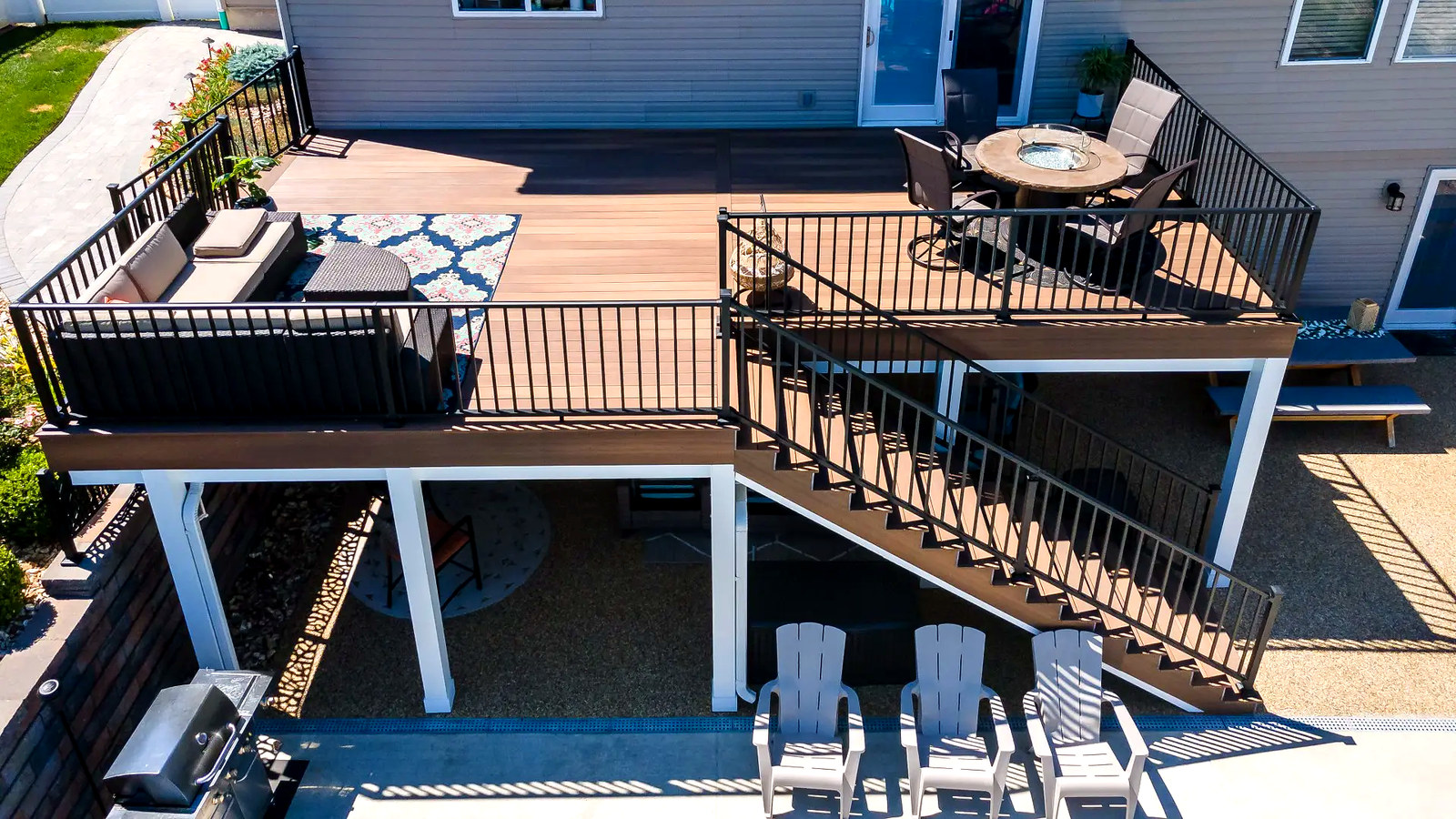 Aerial view of multi-zone backyard deck with dining area, fire-pit lounge and stairs, Connecticut carpentry project
