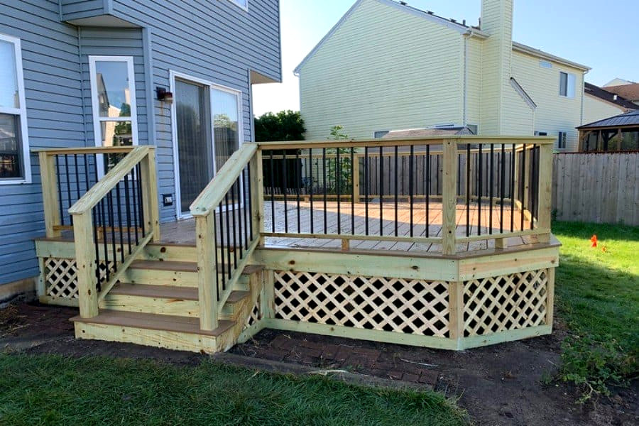 Pressure-treated wood deck with painted railings, lattice skirt and stairs, Connecticut carpentry project