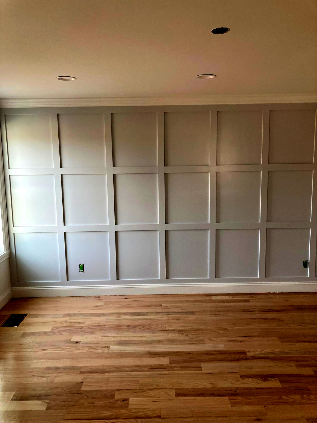 Custom board-and-batten accent wall painted soft gray — Connecticut interior project