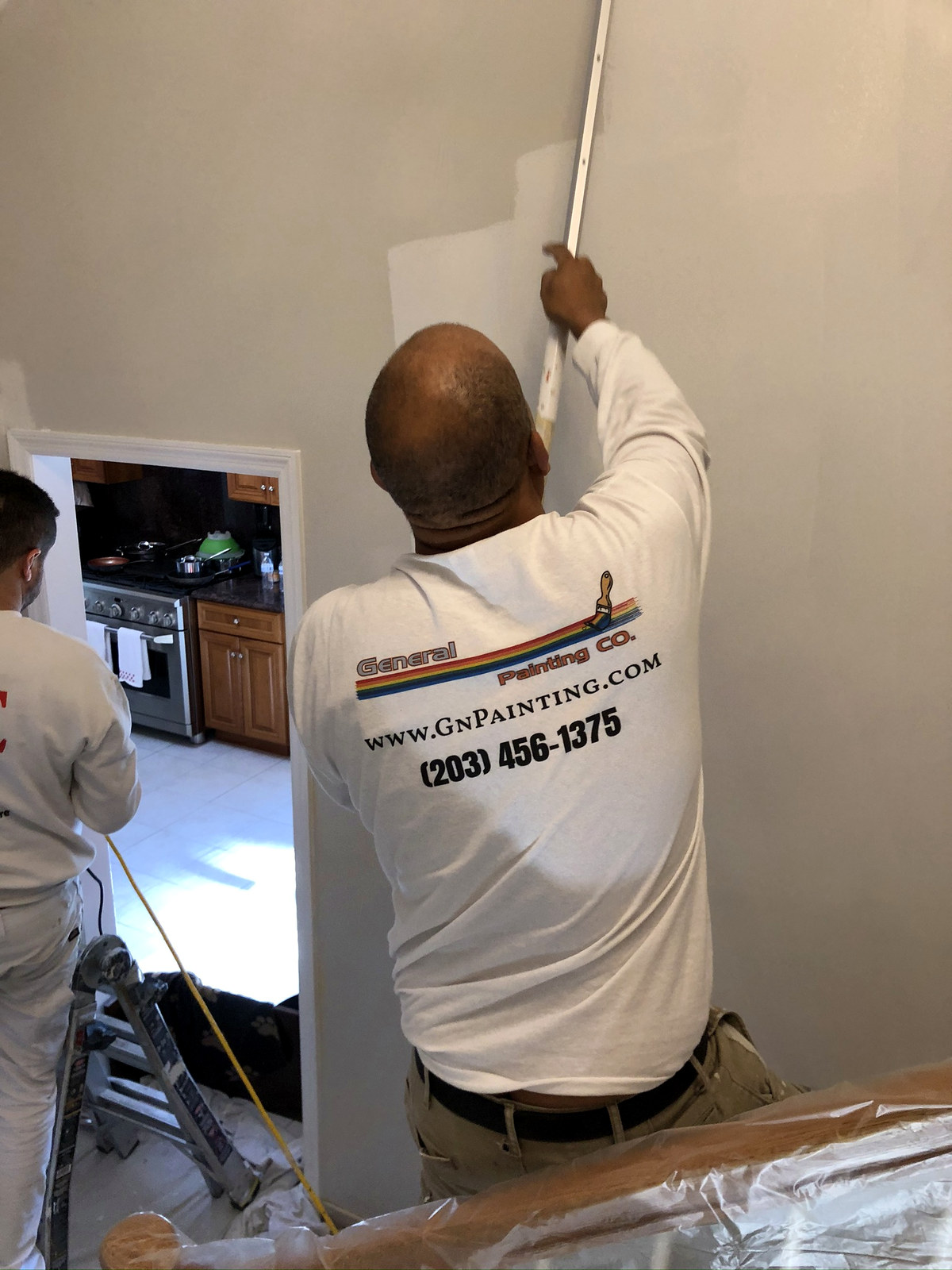 General Painting Co. team in branded shirts cutting in walls — Connecticut interior project