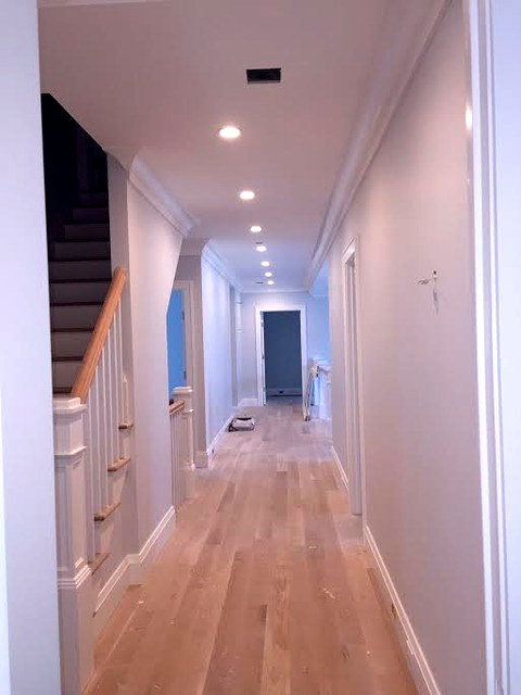 Long second-floor hallway with fresh light gray walls and crisp white trim — Connecticut interior project