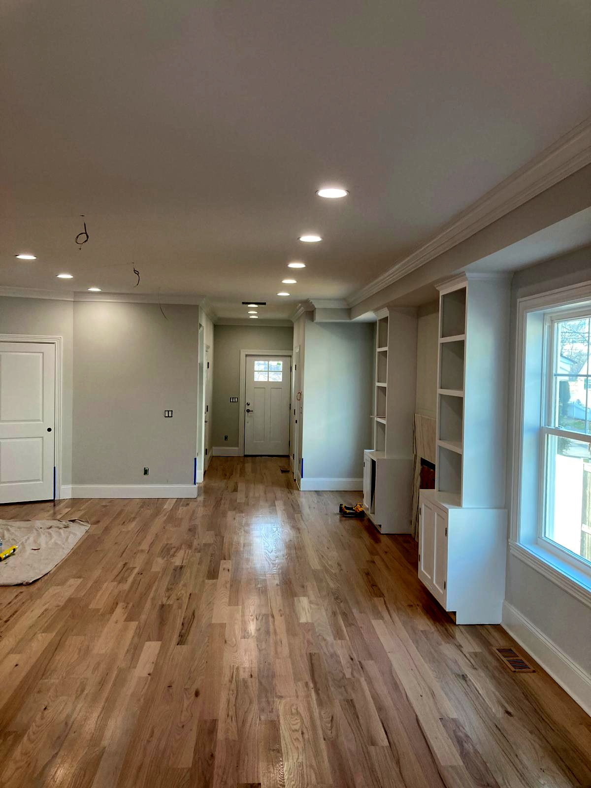 Open-concept living and dining room with soft gray walls and white trim — Connecticut interior painting