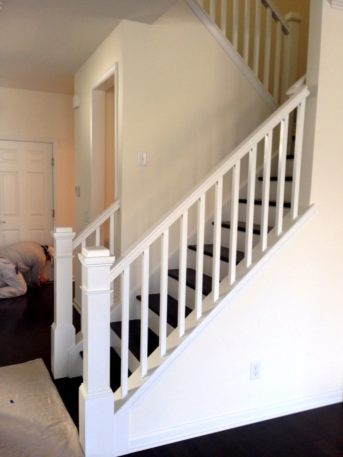 Crisp white painted staircase newel post and balusters — Connecticut interior project